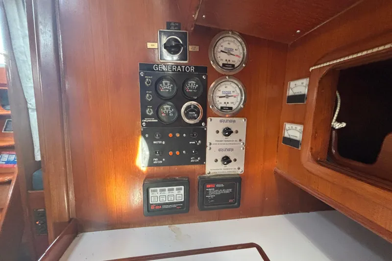 Slide: The Image of Control panel of a 1988 Tayana 52 yacht with gauges and switches. - 55