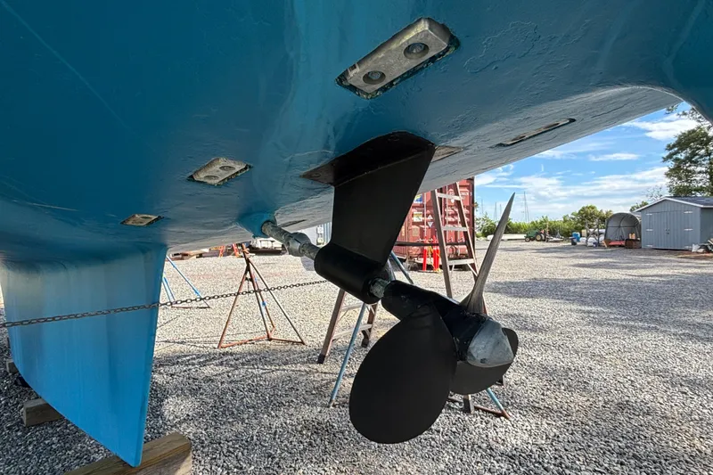 Slide: The Image of Bottom view of a 1988 Tayana 52 sailboat, showcasing its propeller and rudder. - 20