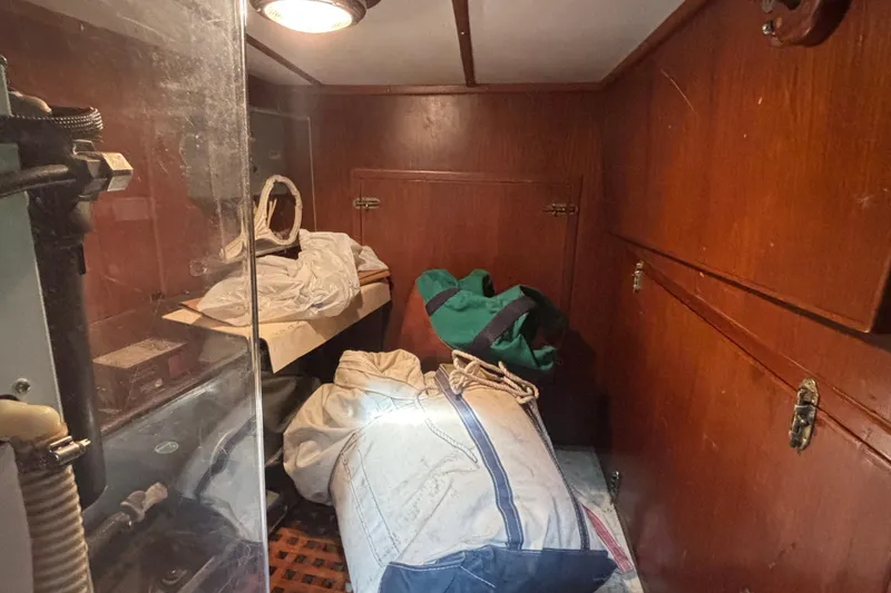 Slide: The Image of Interior of 1988 Tayana 52 sailboat with storage bags and wooden cabinetry. - 68