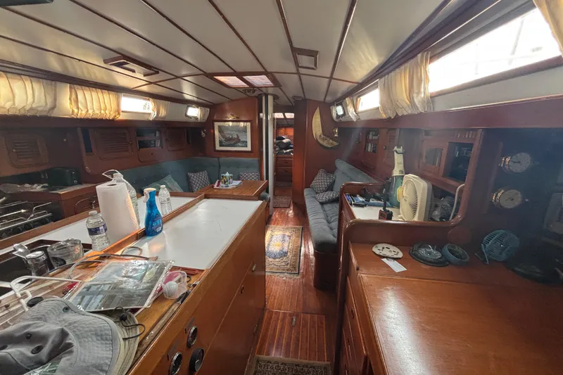 Slide: The Image of Interior of 1988 Tayana 52 yacht with wooden furnishings and cozy seating area. - 47