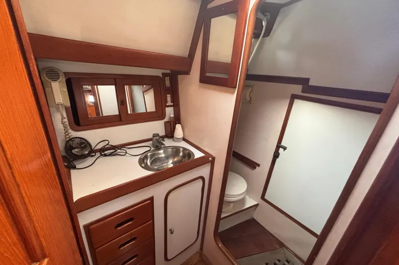 Slide: The Image of Interior of 1988 Tayana 52 yacht bathroom with sink, mirror, and toilet. - 43