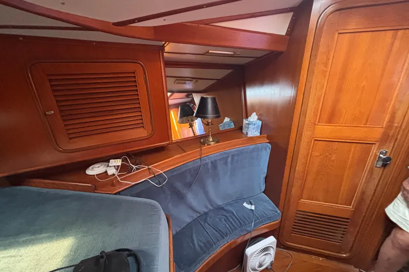 Slide: The Image of Cozy interior of 1988 Tayana 52 yacht with wooden paneling and seating area. - 61