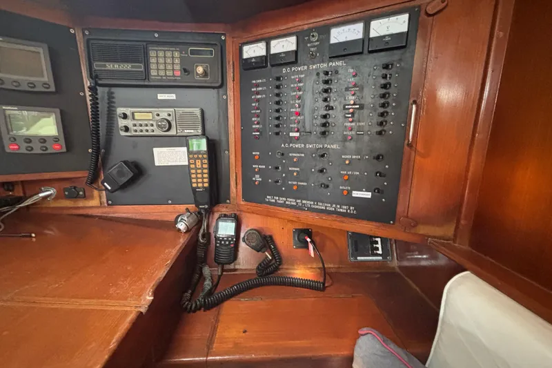 Slide: The Image of Control panel of a 1988 Tayana 52 yacht with communication devices and power switches. - 51