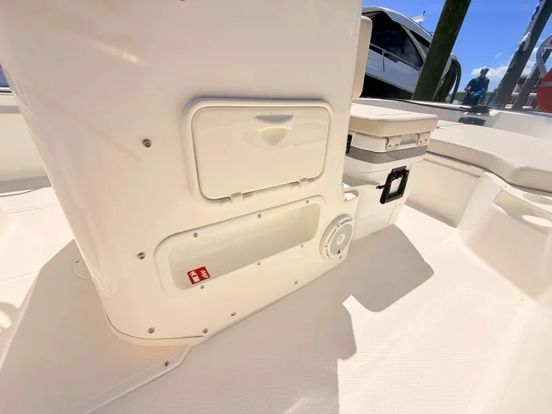 Slide: The Image of The image shows the cockpit of a Boston Whaler 190 Montauk with storage compartments and a speaker. - 37