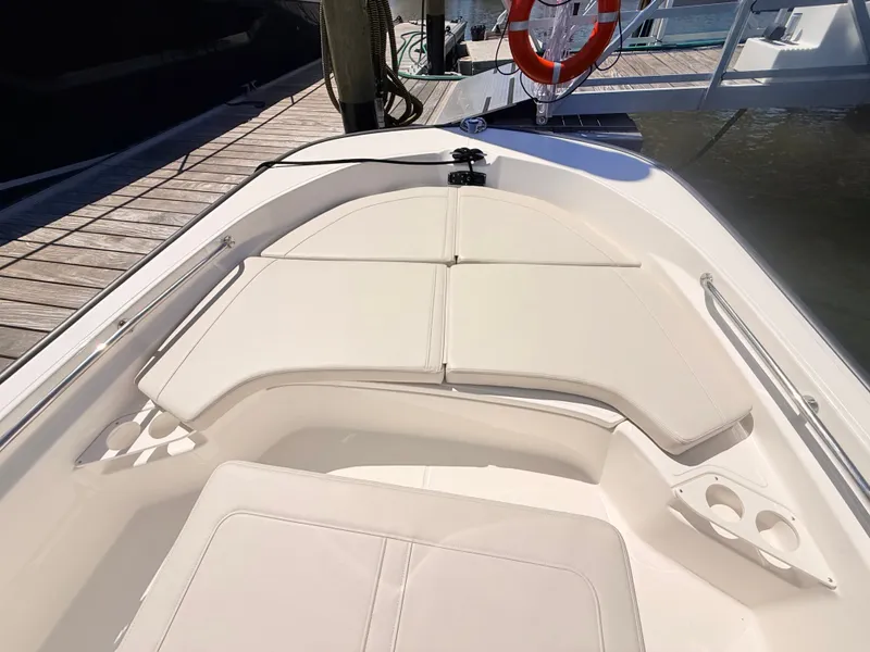 Slide: The Image of The image shows the bow area of a Boston Whaler 190 Montauk with cushioned seating and cup holders. - 39
