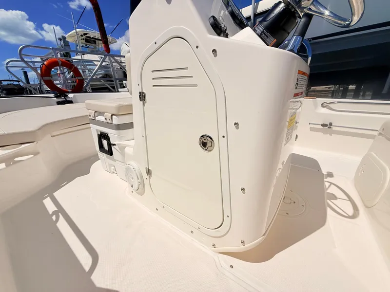 Slide: The Image of The image shows the cockpit of a 2027 Boston Whaler 190 Montauk with a helm console and seating. - 32
