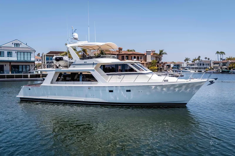 The Image of 2005 Offshore Yachts 54 Pilothouse cruising in a scenic waterfront setting. - 1