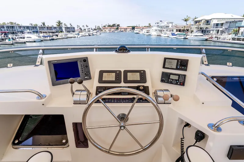 Slide: The Image of Pilothouse of 2005 Offshore Yachts 54, featuring navigation equipment and steering wheel. - 15