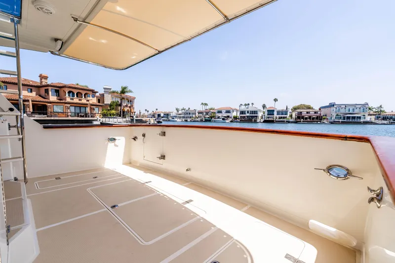 Slide: The Image of Spacious deck of 2005 Offshore Yachts 54 Pilothouse with waterfront view. - 18