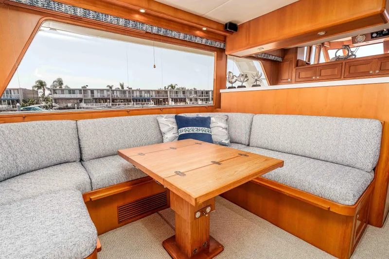 Slide: The Image of Luxurious interior of 2005 Offshore Yachts 54 Pilothouse with elegant seating and wooden table. - 23