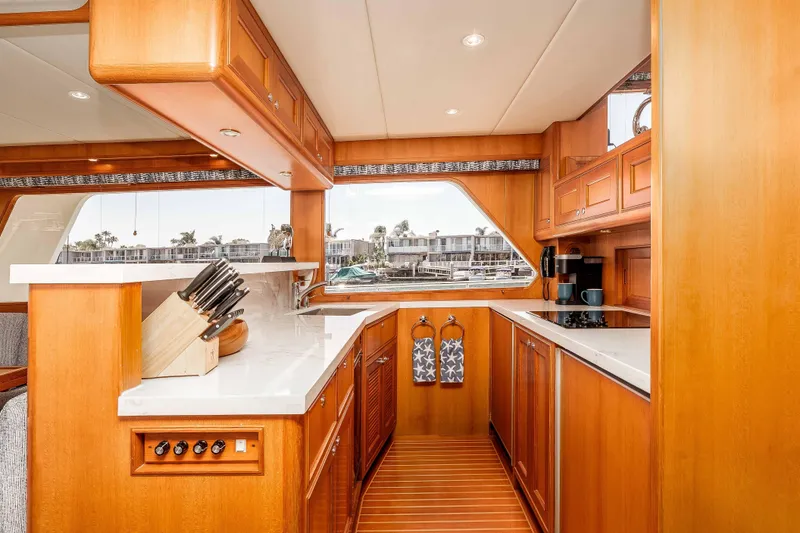 Slide: The Image of Luxurious 2005 Offshore Yachts 54 Pilothouse kitchen with wood cabinetry and modern appliances. - 27