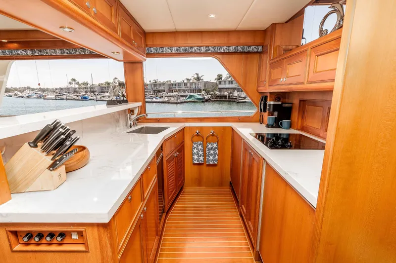 Slide: The Image of Luxurious 2005 Offshore Yachts 54 Pilothouse kitchen with wood cabinetry and marina view. - 28