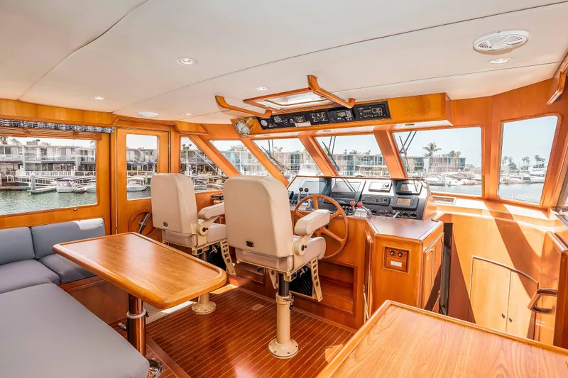 Slide: The Image of Pilothouse interior of 2005 Offshore Yachts 54 Pilothouse, featuring helm and seating area. - 29