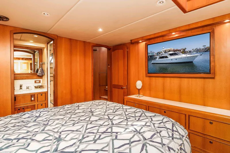 Slide: The Image of Luxurious 2005 Offshore Yachts 54 Pilothouse bedroom with elegant wood paneling and modern amenities. - 34