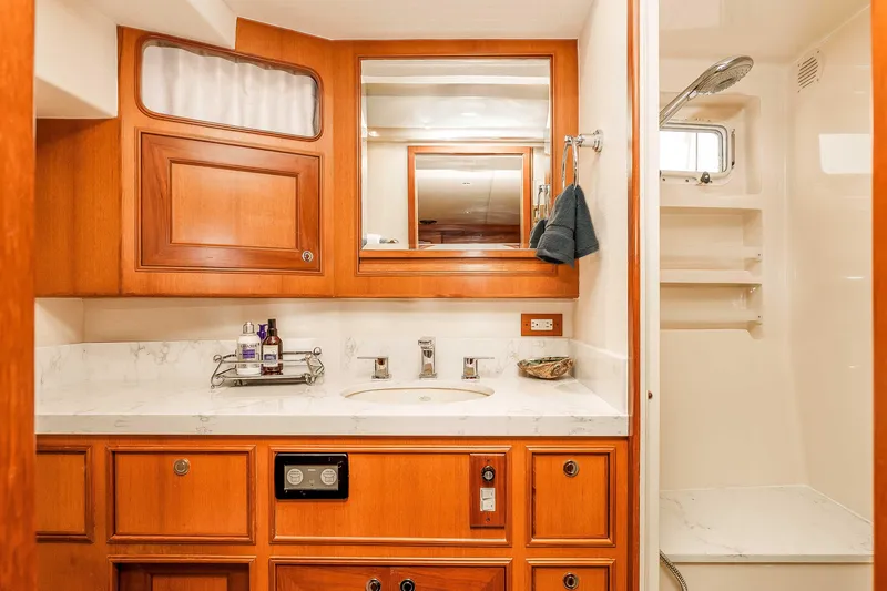 Slide: The Image of Luxurious bathroom in 2005 Offshore Yachts 54 Pilothouse with wood cabinetry and marble countertop. - 35