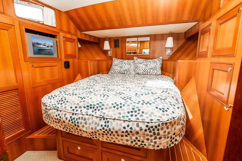 Slide: The Image of Luxurious 2005 Offshore Yachts 54 Pilothouse cabin with cozy bed and elegant wood paneling. - 36