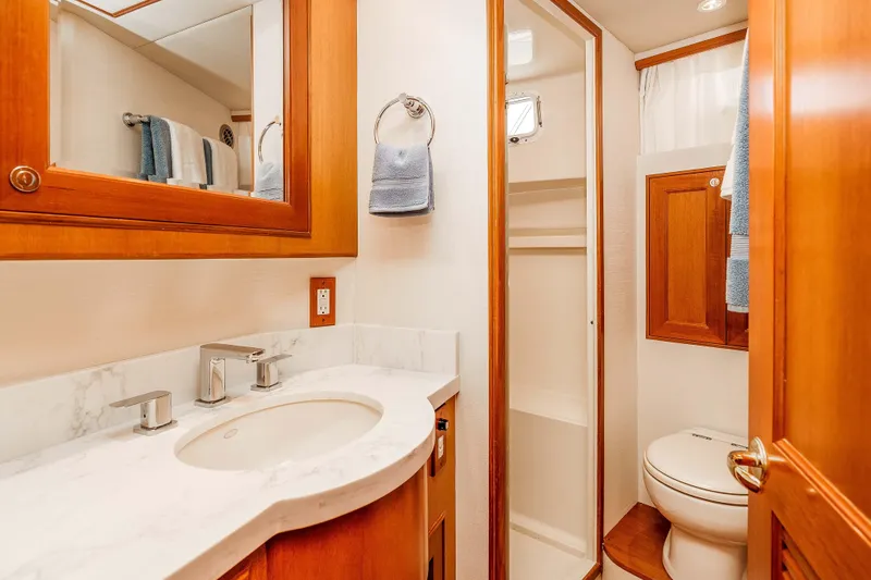 Slide: The Image of Luxurious bathroom in 2005 Offshore Yachts 54 Pilothouse, featuring elegant wood cabinetry and modern fixtures. - 38