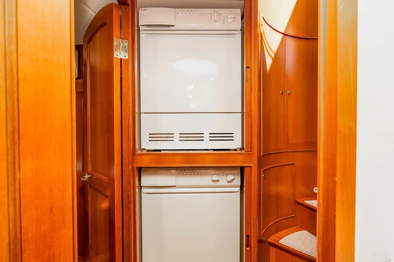 Slide: The Image of Laundry area in 2005 Offshore Yachts 54 Pilothouse, featuring stacked washer and dryer. - 39