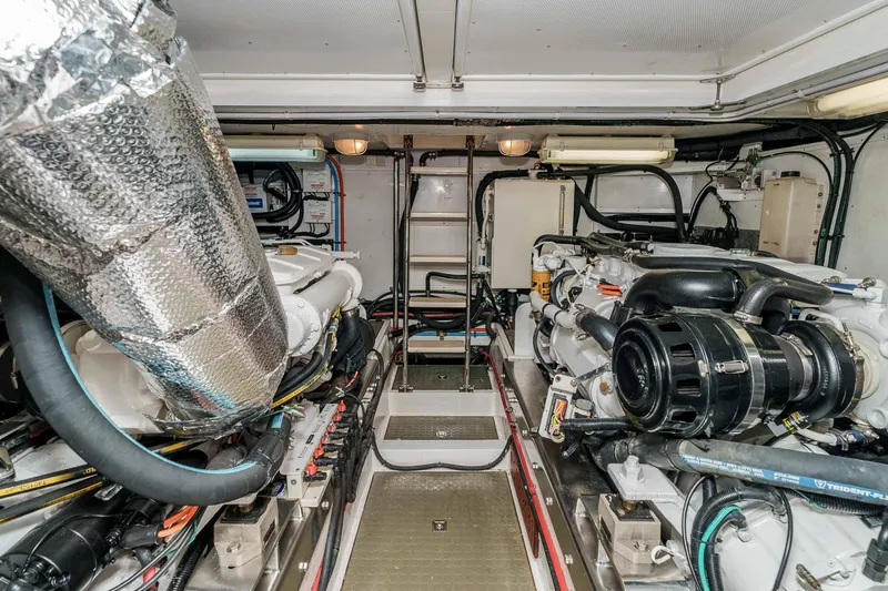 Slide: The Image of Engine room of 2005 Offshore Yachts 54 Pilothouse, showcasing dual engines and mechanical systems. - 40