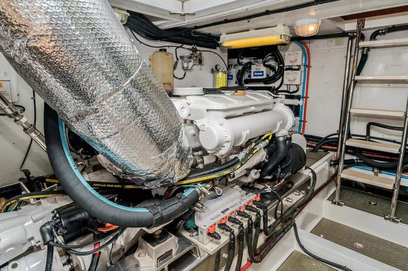 Slide: The Image of Engine room of 2005 Offshore Yachts 54 Pilothouse, showcasing machinery and wiring. - 41