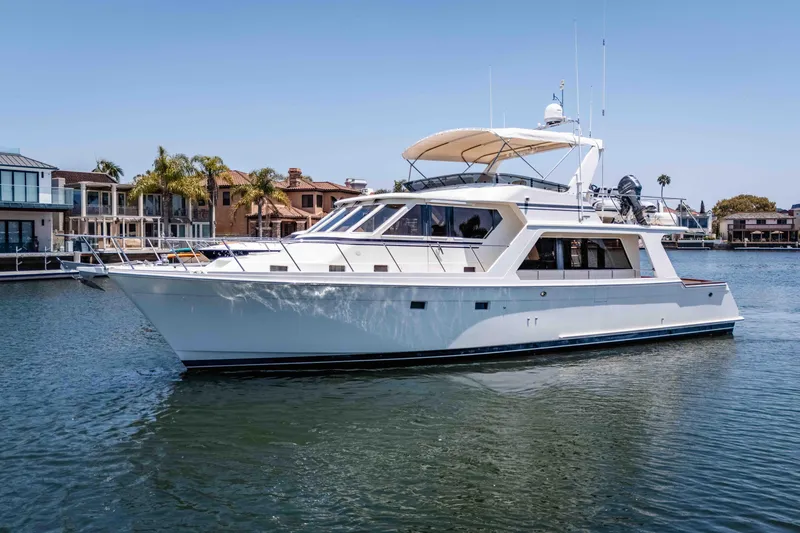 Slide: The Image of 2005 Offshore Yachts 54 Pilothouse cruising in a serene waterfront setting. - 6