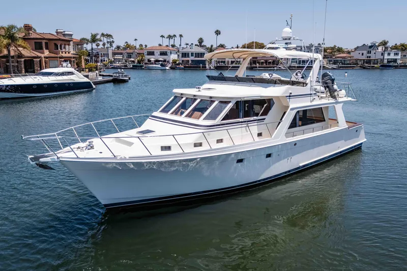 Slide: The Image of 2005 Offshore Yachts 54 Pilothouse cruising in a scenic marina setting. - 7
