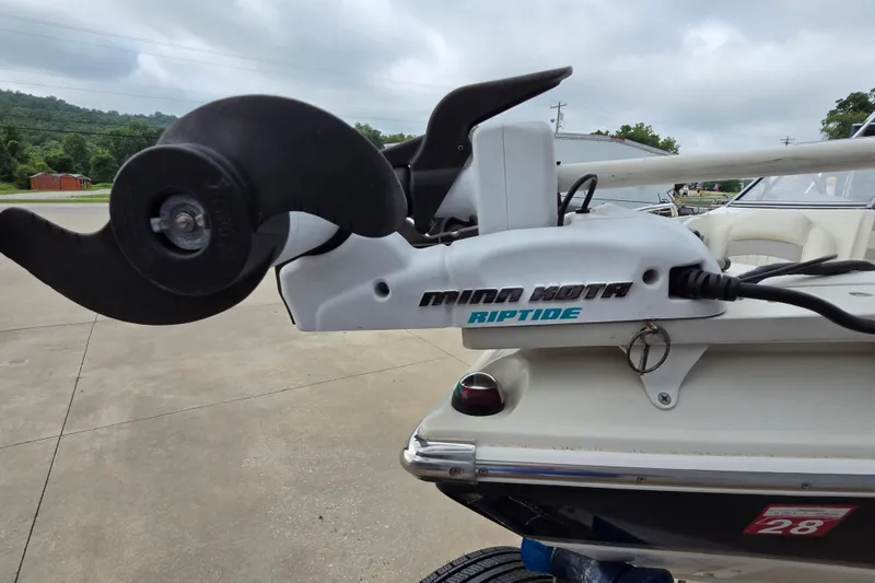 Slide: The Image of Minn Kota Riptide motor on 2013 Stingray 191 LX boat, parked outdoors. - 14