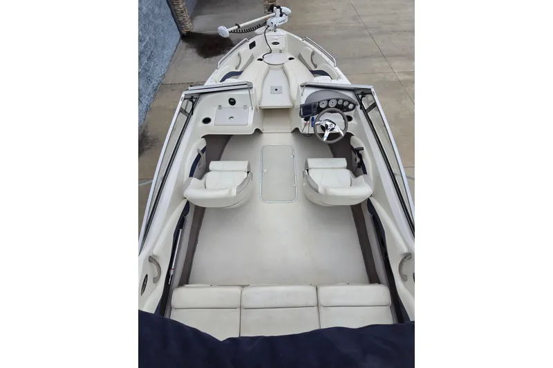Slide: The Image of 2013 Stingray 191 LX boat interior with white seating and steering console. - 5