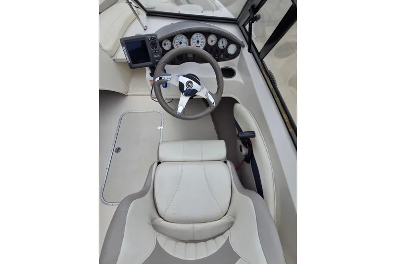 Slide: The Image of 2013 Stingray 191 LX boat cockpit with steering wheel and dashboard controls. - 6