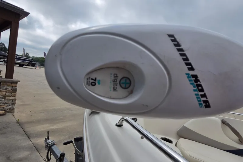 Slide: The Image of Minn Kota Riptide motor on 2013 Stingray 191 LX boat, parked outdoors. - 7