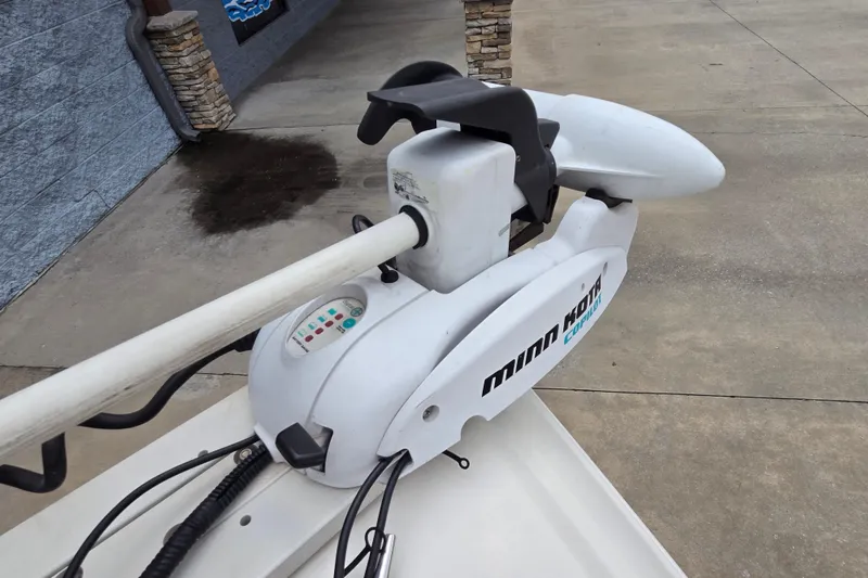 Slide: The Image of Minn Kota trolling motor on a 2013 Stingray 191 LX boat, parked on concrete. - 8