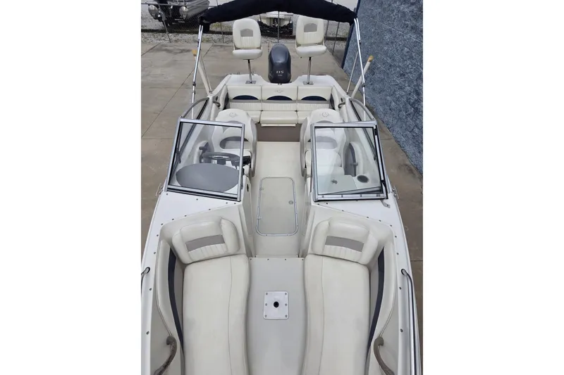 Slide: The Image of 2013 Stingray 191 LX boat interior with seating and steering wheel, featuring a sleek design. - 9