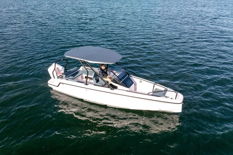 Slide: The Image of Axopar 22 T-Top 2026 on calm water. - 11