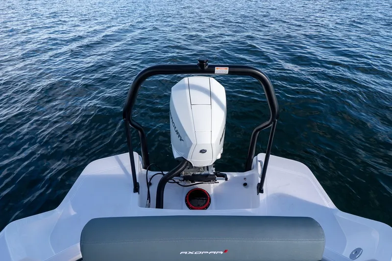 Slide: The Image of Axopar 22 T-Top 2026 on calm water with outboard motor. - 21