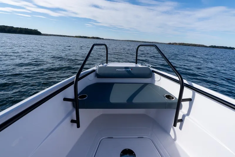 Slide: The Image of Axopar 22 T-Top 2026 on calm water with blue sky. - 26