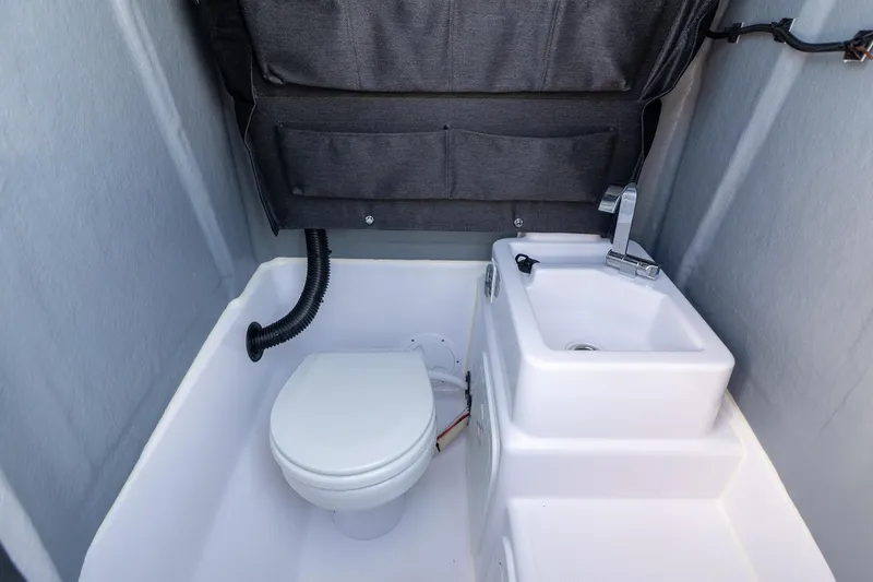 Slide: The Image of Interior of Axopar 22 T-Top 2026 with toilet and sink. - 27