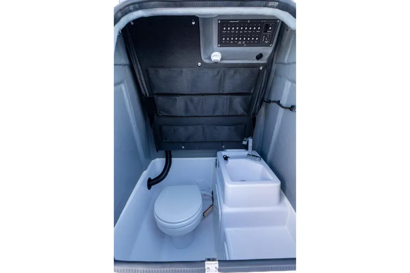Slide: The Image of Interior of Axopar 22 T-Top 2026 with toilet and sink. - 28