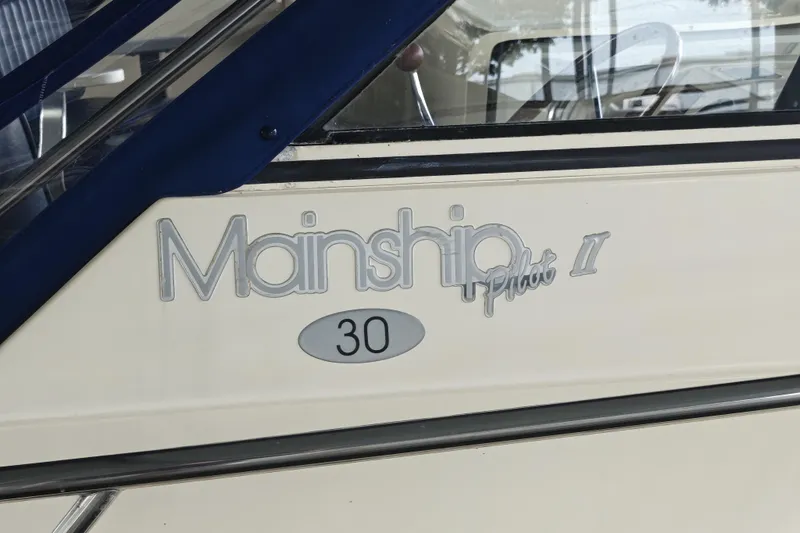 Slide: The Image of 2003 Mainship Pilot 30-II boat logo on side panel. - 14