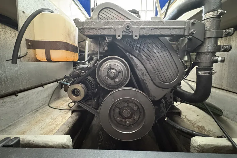 Slide: The Image of Engine compartment of a 2003 Mainship Pilot 30-II boat, showcasing mechanical components. - 18