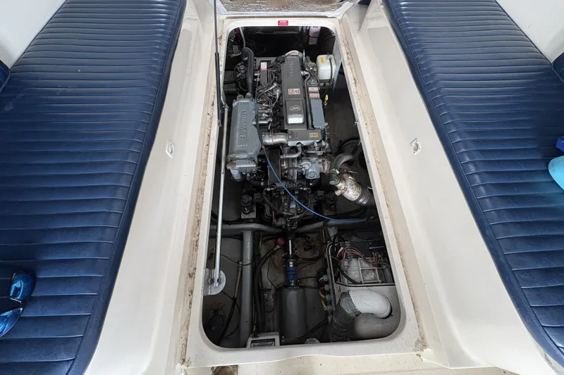 Slide: The Image of Engine compartment of a 2003 Mainship Pilot 30-II boat with blue seating. - 16