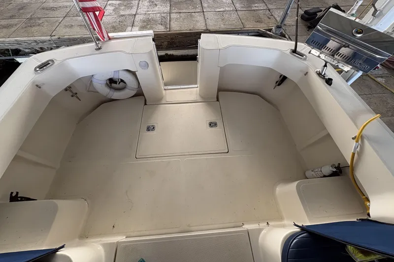 Slide: The Image of 2003 Mainship Pilot 30-II boat deck with seating, life preserver, and grill. - 7