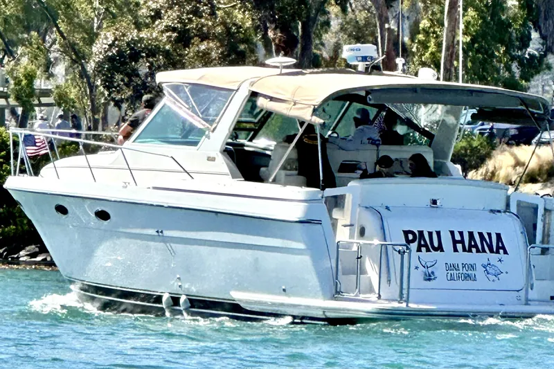 The Image of 1998 Tiara Yachts 3500 Express cruising in sunny waters, named "Pau Hana." - 0