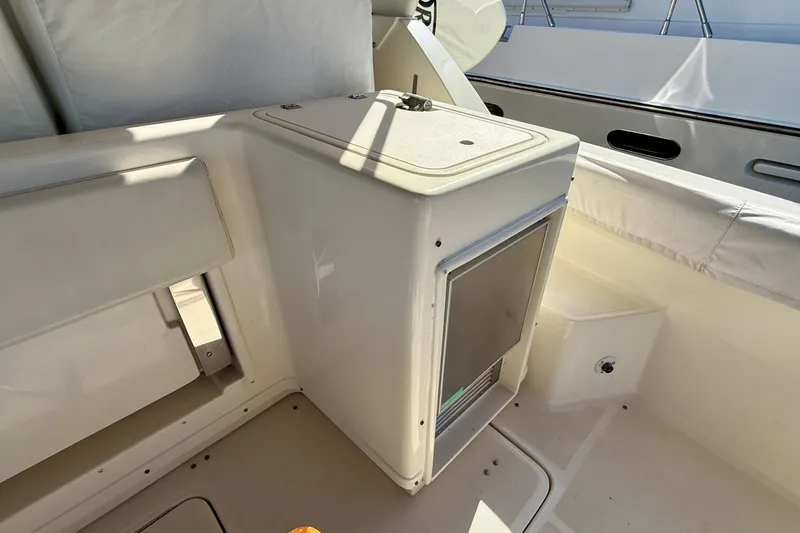 Slide: The Image of 1998 Tiara Yachts 3500 Express interior with seating and storage compartment. - 13