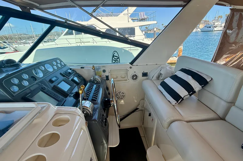 Slide: The Image of Interior of a 1998 Tiara Yachts 3500 Express, featuring helm and seating area. - 17