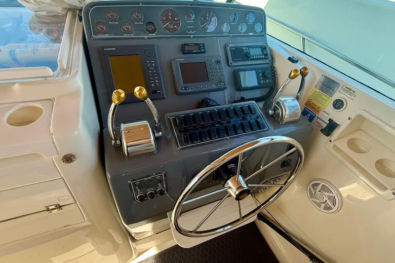 Slide: The Image of Helm of 1998 Tiara Yachts 3500 Express with steering wheel and navigation controls. - 18