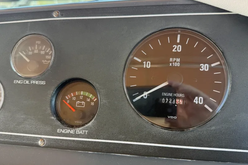 Slide: The Image of Dashboard gauges of a 1998 Tiara Yachts 3500 Express, showing RPM and engine hours. - 19