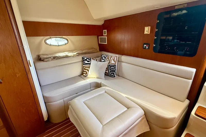 Slide: The Image of Interior of 1998 Tiara Yachts 3500 Express with plush seating and decorative pillows. - 23