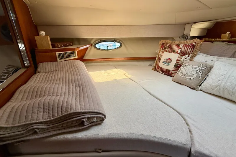 Slide: The Image of Cozy cabin interior of 1998 Tiara Yachts 3500 Express with decorative pillows and bedding. - 29