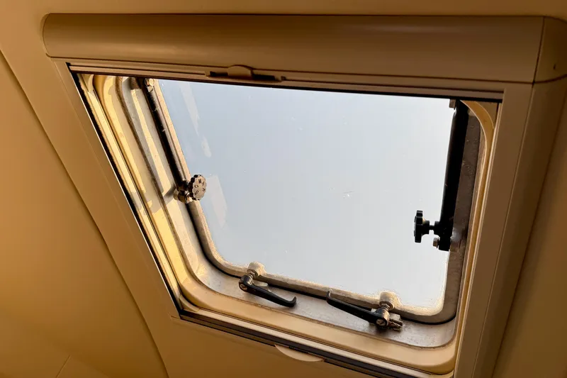 Slide: The Image of Hatch window of a 1998 Tiara Yachts 3500 Express, showcasing marine craftsmanship. - 30