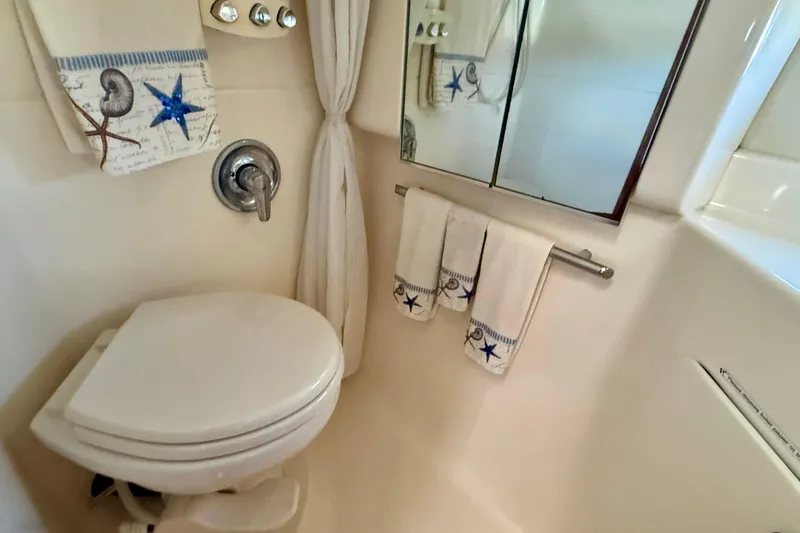 Slide: The Image of Bathroom interior of 1998 Tiara Yachts 3500 Express with nautical-themed decor. - 35